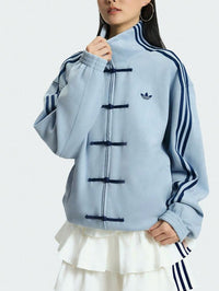 Close up of aqua blue streetwear jacket layered perfectly over a Chinese New Year shirt 2026