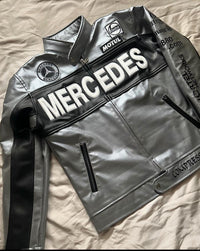 Gray and black oversized leather track jacket with dropped shoulders and racing graphics
