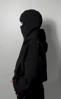 Side view of a jet black balaclava hoodie made from heavyweight cotton, urban streetwear style