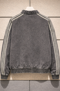 Gray jacket with striped sleeves on a wooden surface