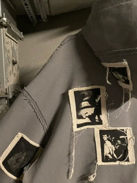 Gray streetwear jacket with raw seam details and black graphic fabric patches, Y2K fashion style