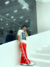 Lifestyle shot of a person walking, showcasing the movement and tech-twill drape of Uibok 90s style breakaway pants.