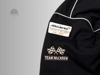 McLaren Formula 1 team patches against the stealth black background.