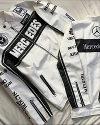 White F1 aesthetic track jackets with black details and sponsor logos, laid flat on fabric.