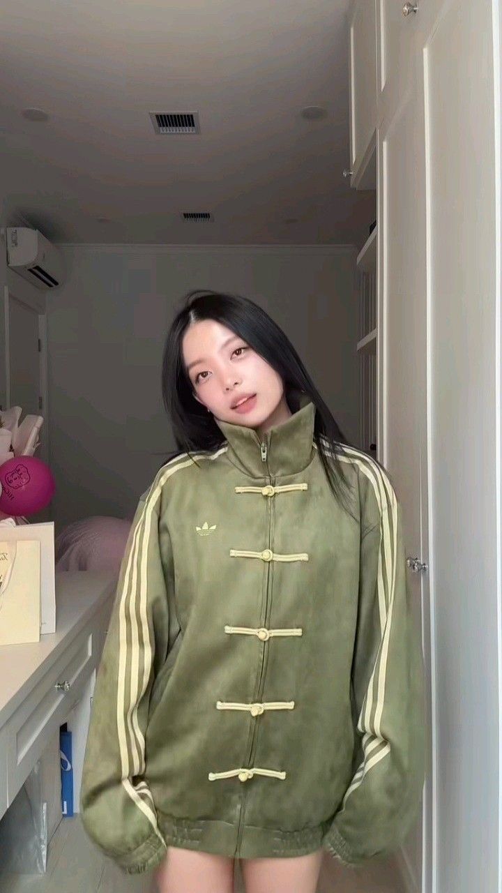 Showcasing the boxy relaxed fit of the Uibok green Lunar New Year outerwear