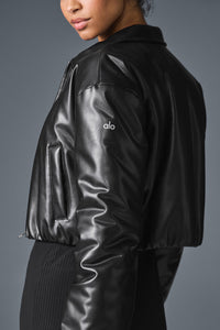 Side profile of uibok black cropped leather jacket showing sleeve and waist fit
