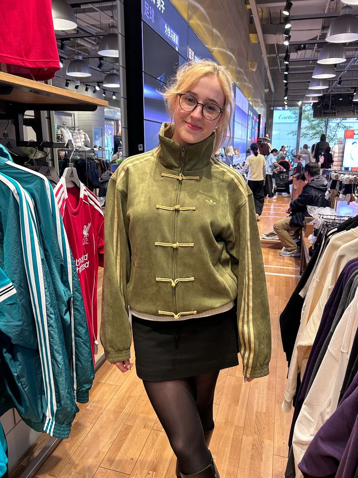 Streetwear model styling the Uibok olive green CNY edition jacket with beige cargo pants