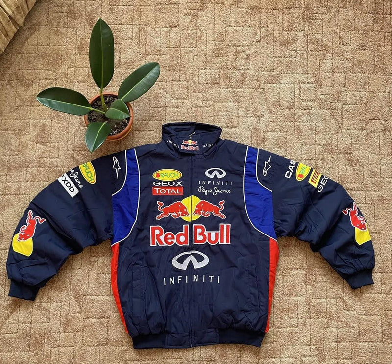 Vintage Red Bull motorsport embroidered racing jacket with oversized fit, displayed on carpet.