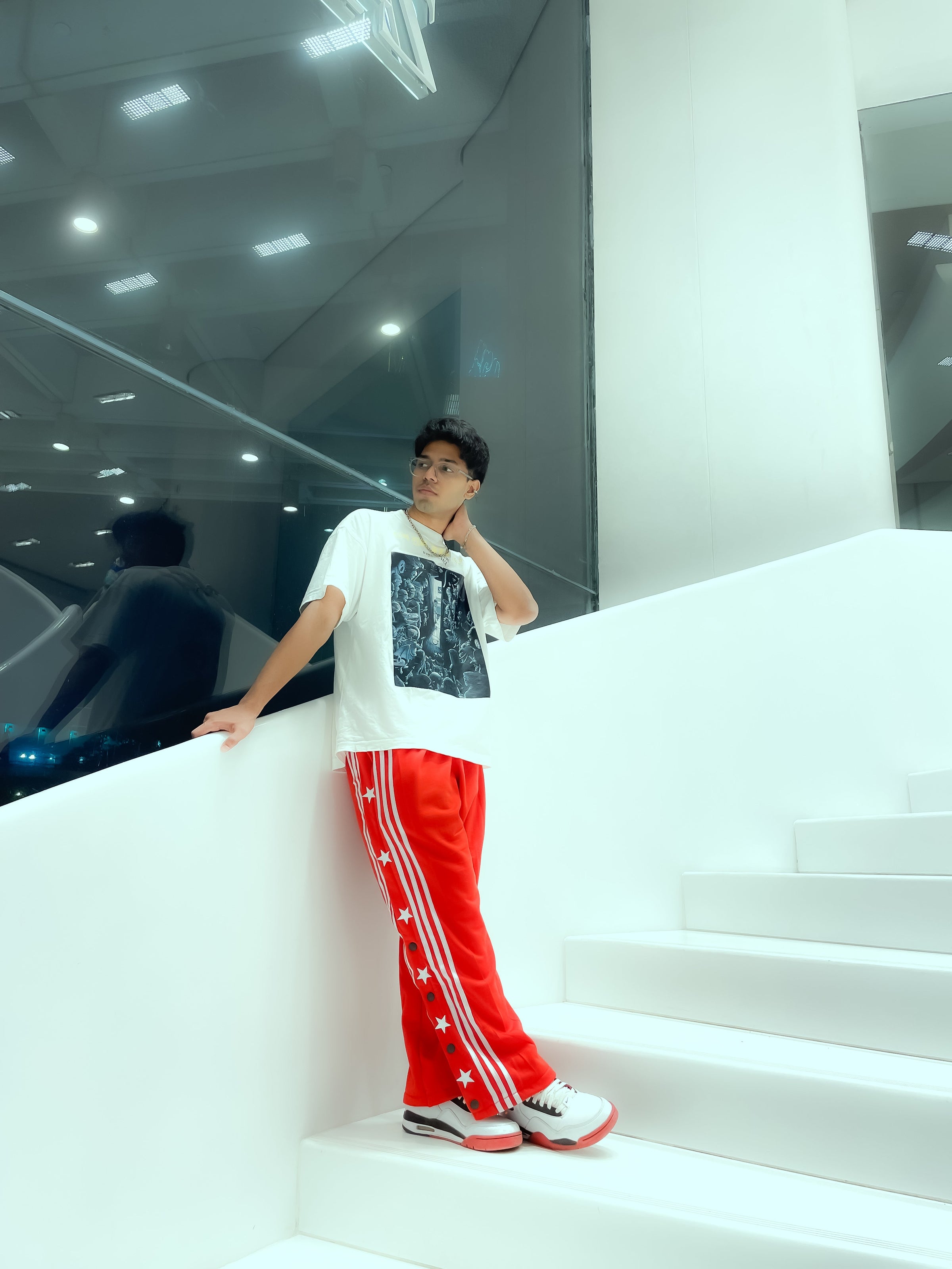 Uibok black retro snap button track pants showing elastic waistband and back pocket detail.