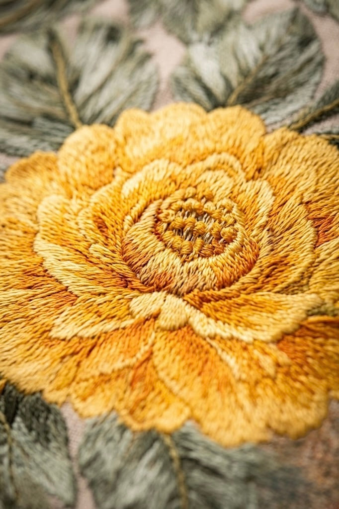 Detailed view of traditional Chinese floral motif and 3D raised embroidery on premium oriental streetwear pants.