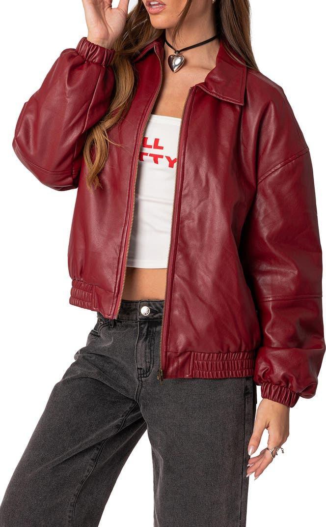 Oversized red matte streetwear jacket with elastic cuffs, styled with casual Y2K clothing.