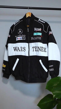 Black and white F1-inspired streetwear jacket with bold graphic logos and embroidered patches.