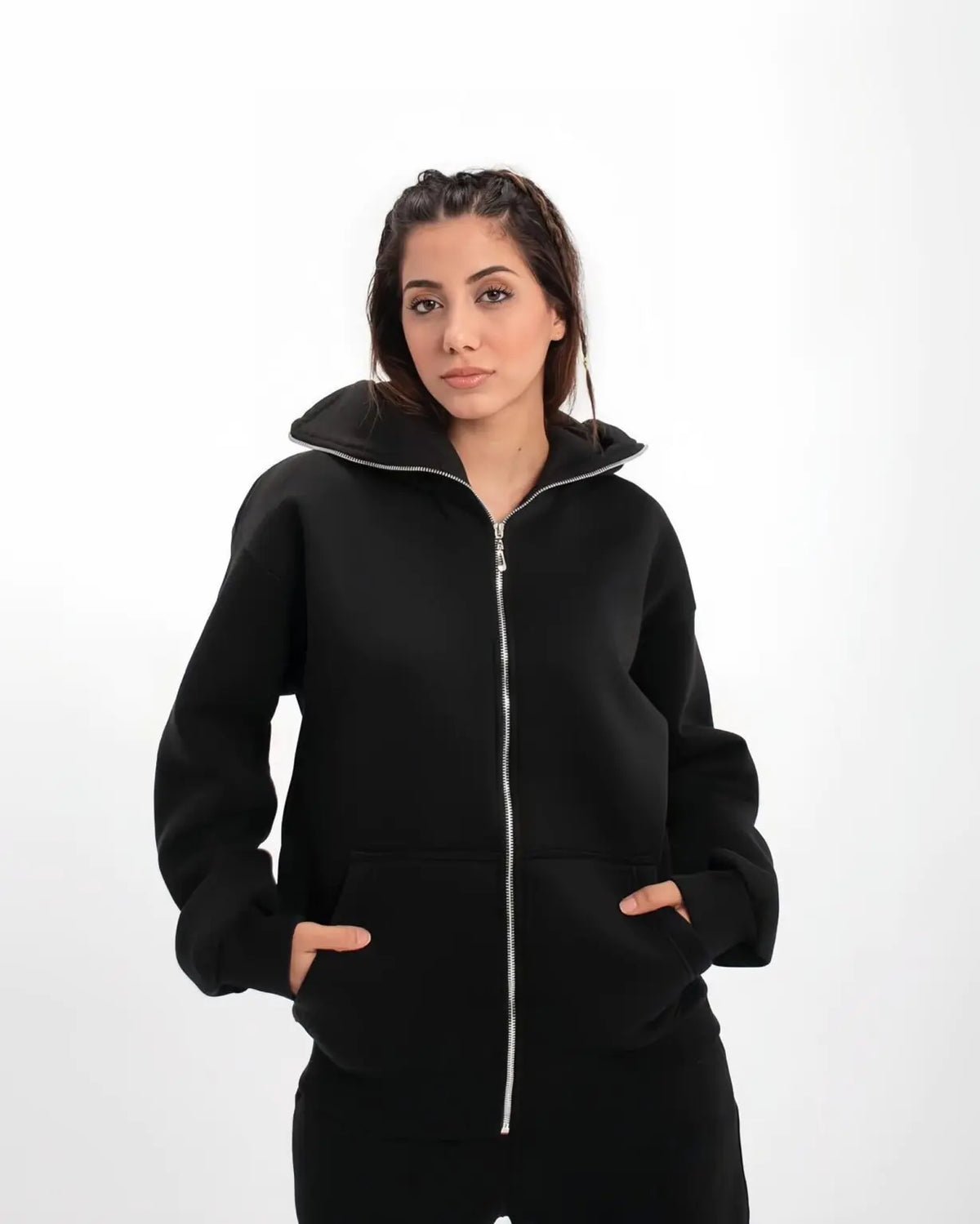 Model wearing Uibok achromatic black balaclava hoodie demonstrating anatomical stealth for cyber-goth techwear aesthetic.