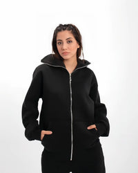 Model wearing Uibok achromatic black balaclava hoodie demonstrating anatomical stealth for cyber-goth techwear aesthetic.